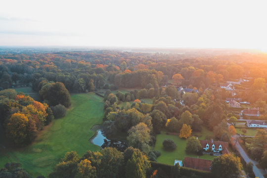 Aerial view of a golf lawn during sunrise with colourful trees, Sint-Martens-Latem, Belgium