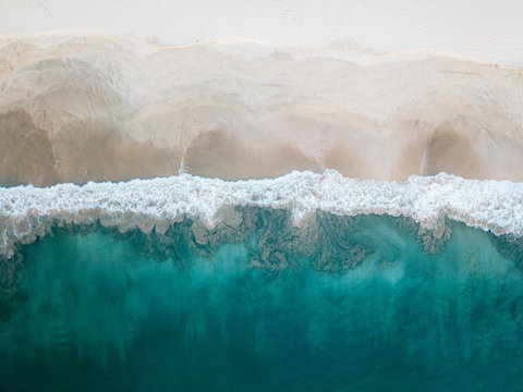 Aerial view of sandy beach with wave in Lampuuk, Aceh, Indonesia.