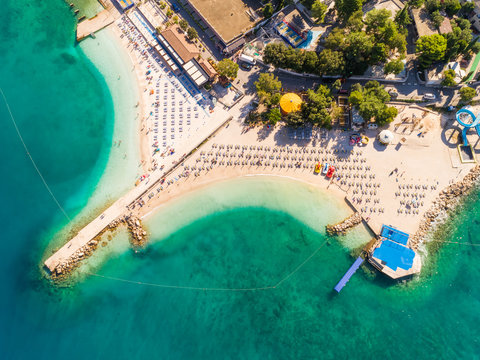 Aerial view of chairs on the shore of Poli Mora beach on sunny day in Crikvenica, Croatia.