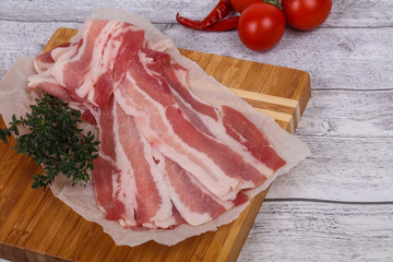 Raw bacon on the board