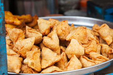 lots of indian samosa on a plate