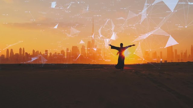 Woman rised her arms on the Dubai city background with on sunset. City connected to 5G technology