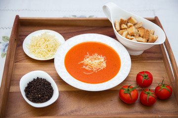 Red lentil soup . Spaghetti white plate . Dry bread and pepper . Red tomatoes . Tomato Soup wooden tray .