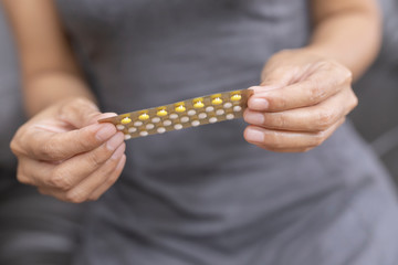 Woman holding combined oral contraceptive pill.Gynecology concept.