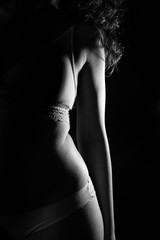 model in underwear or lingerie. Black and white photographs with black background
