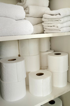 White Towels And Toilet Paper On Shelves