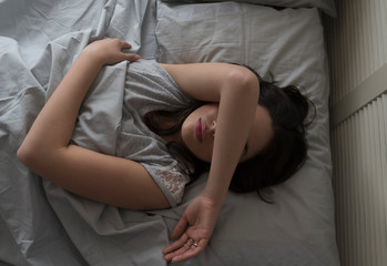 Elevated view of young woman sleeping in bed