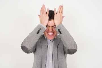 Exasperate male keeps hands on temples, feels strong headache, closes eyes with pain, need healthy...