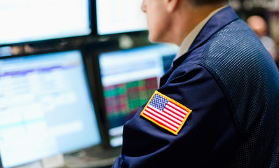 Stock trader with american flag on sleeve