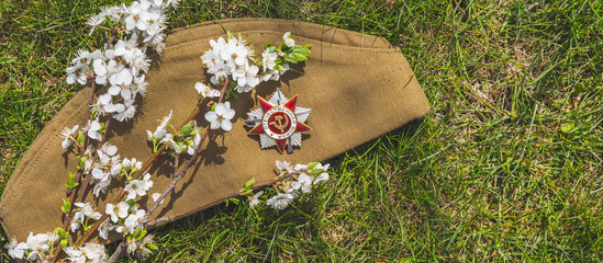 May 9, Victory Day holiday. Holiday card with order, St. George ribbon, flowers and military cap....