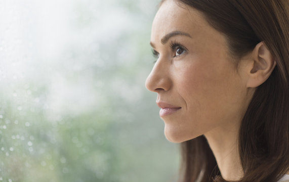Woman next to rainy window