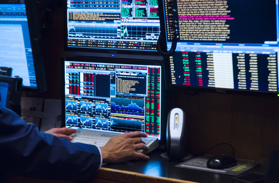 Stock trader working on computer