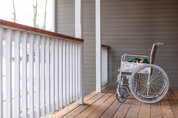 Empty wheelchair†on porch