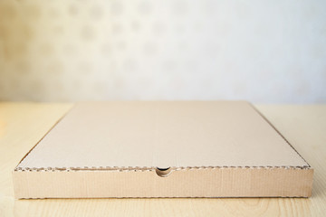 Blank brown cardboard Pizza paper box on the table. Packaging template mockup collection. Stand-up Front view package.