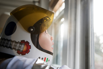 Girl wearing astronaut helmet