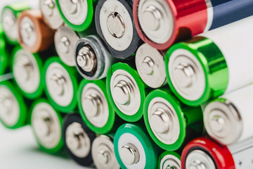 Closeup of group of used disposable  batteries of various color.