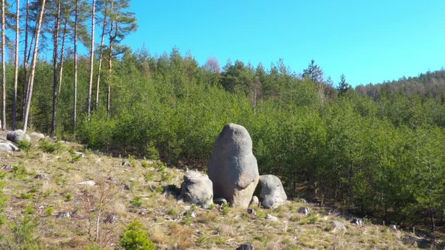 Ancient stone monument. Celtic Menhir in Sedmihori hills. Mysterious landmark in Western Bohemia. Czech Republic, Central Europe.