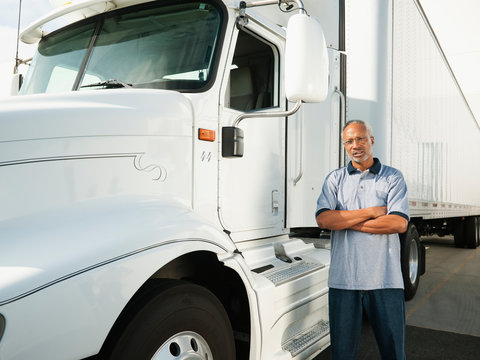 Truck driver standing near truck