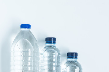 Naklejka premium three plastic bottles filled with mineral water from above