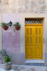 bring yellow door with decorative potplants in vintage setting