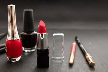 Make-up cosmetics accessories against black background