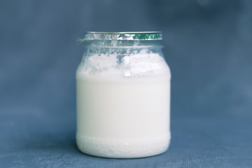 Yogurt in a glass package on a dark gray background. Healthy Nutrition, Essential Dairy Products