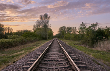 Railroad track in countryside at sunset, Rastatt, Germany