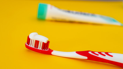 Bright toothbrushes for personal care dental care on a yellow background. Selective focus Top view with copy space for text.