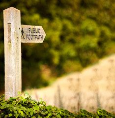 Wooden post saying public footpath