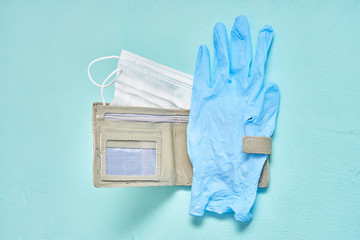 medical mask leather wallet and blue latex glove. virus and economics concept