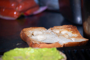 Fast food prepared on the street in Guatemala, Central America, bread with sausages, cabbage, avocado and sauces, called Shuco Chapina version of hot dog, danger of contagion of diseases and Covid 19.