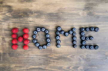 The concept of the word image - stay home written on a wooden background with fruits.