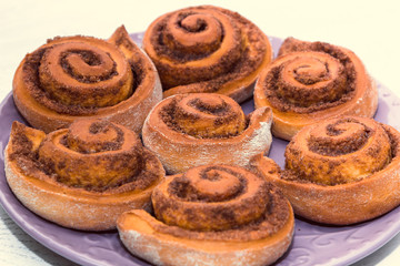 rolled bread rolls with sugar and cinnamon baked in the home kitchen as an example of home baking