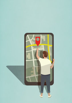 Man reaching for map pin icon on large smart phone