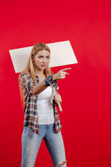 Emotional young blonde woman with a white banner for slogans in her hands expresses a protest and...