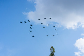 A group of professional pilots of military aircraft in sky. 