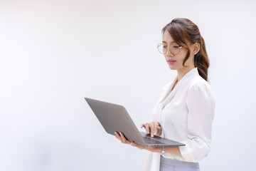 Portrait of  business looking at laptop and workking in office. Young business colleagues discussing work in the office.