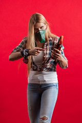 Emotional young blonde woman in a protective mask on her face with a Molotov cocktail in her hands protests