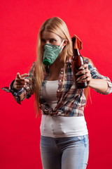 Emotional young blonde woman in a protective mask on her face with a Molotov cocktail in her hands protests