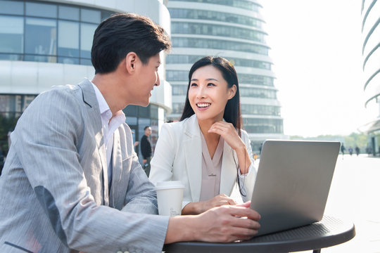 Business people discuss working outdoors