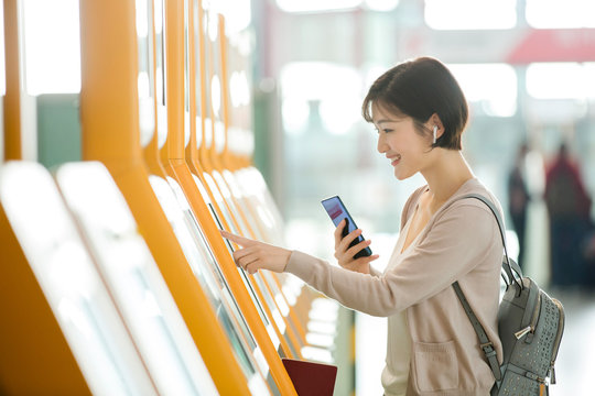 Business lady in the airport to use automatic machines