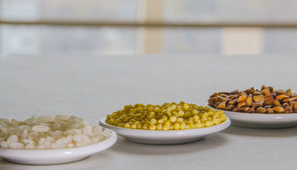 Set of colors food rice millet buckwheats on the plate on the white background