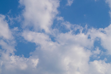 the sky is clear. The top edge of the cloud, like a snake, gleams silver. already round clouds appear, similar to small islands. 