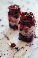 chia seeds, with berry puree on a white blurred background.