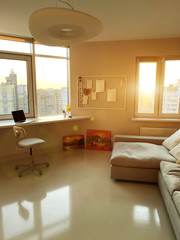 Modern apartment with couch, paintings and laptop