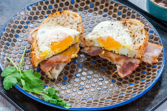 Egg-in-the-hole Bacon Sandwich Cut In Half.