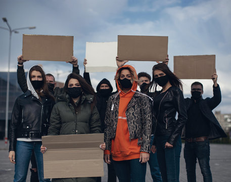 Diverse group of people protesting with blank sign. Protest against human rights, abuse of freedom or racist beliefs