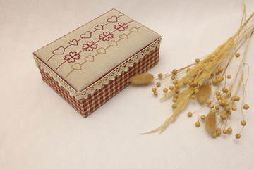old box on a white background and dry grass