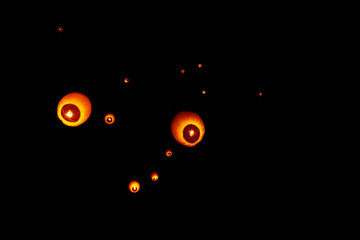 Colorful circle paper floating lanterns are flying to dark night skies in Probarona Purnima festival.