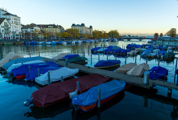 Fototapeta na wymiar A lot of small boats near Limmat river at evening, Zurich
